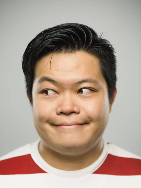 istock Real chinese young man with happy expression looking to the side 1129081463