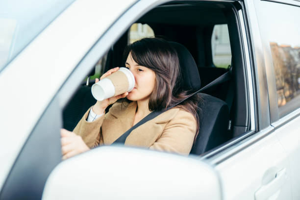 istock woman driving car. safety belt 1129081586