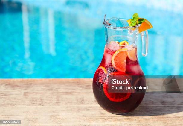 Glass Jug Of Iced Sangria With Strawberry Orange Apple And Lemon Stock Photo - Download Image Now