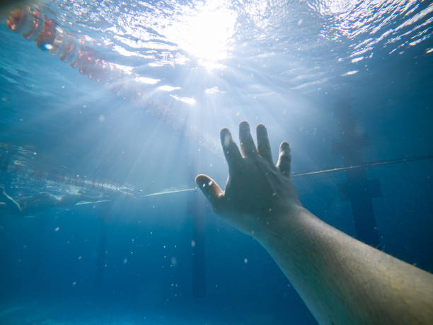 first person view. drowning man under water. air bubbles