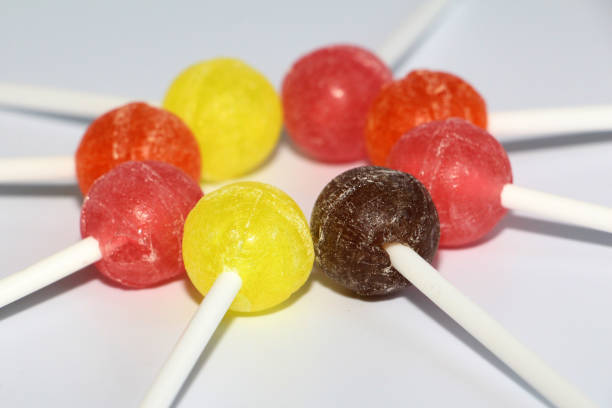 istock Sweet multicolored caramel on a stick. Sweets laid out on the table. 1129083030