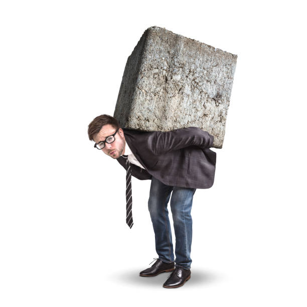 businessman carrying a large and heavy stone on his back - overstrained imagens e fotografias de stock