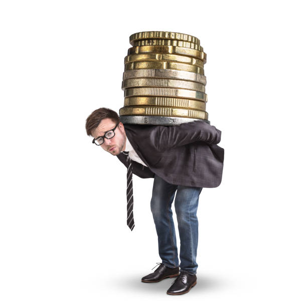 businessman carrying a giant stack of coins on his back - overstrained imagens e fotografias de stock