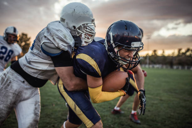 istock Tough American football player making an effort while trying to avoid his opponent. 1129083999