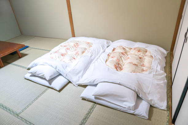 Futon A Japanese Quilted Mattress Rolled Out On The Floor For Use As A Bed  Japan Style Stock Photo - Download Image Now - iStock