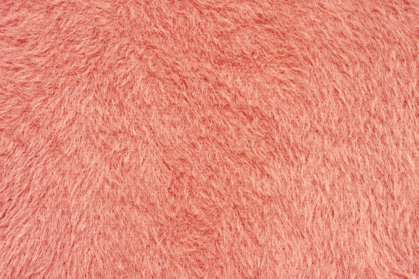 istock Coral colored fluffy fake fur texture 1129085581