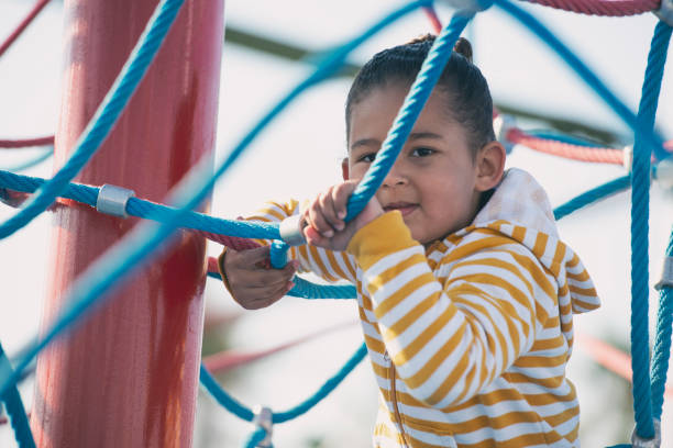 istock Little girl climbing on ropes. 1129088423