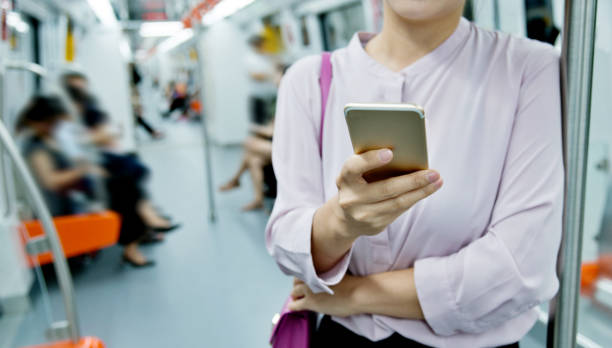 istock Woman hand using phone in the subway train 1129091792