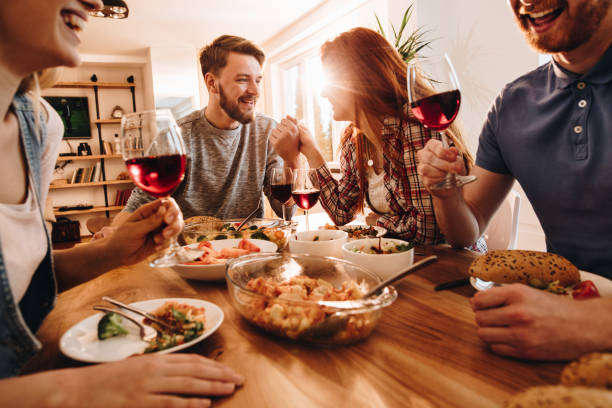 istock Four people enjoying on double date and talking during lunch time. 1129092226