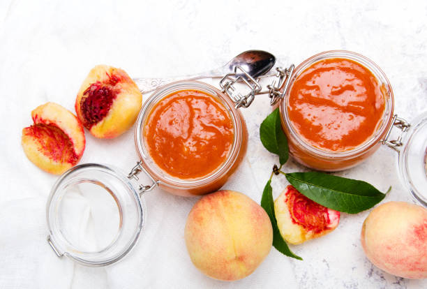 homemade peach jam with organic fruit. sweet preserves on a light background, copy space - preserves jar apricot marmalade imagens e fotografias de stock