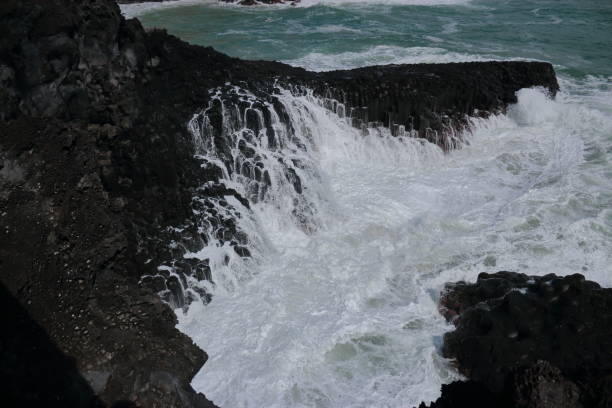 istock Cannon-dong main seungyeoli, waves, volcanic rock, dosing pillars, 1129093874