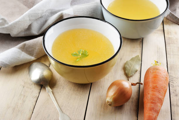istock Homemade broth in the bowls on the  rustic background. 1129094882