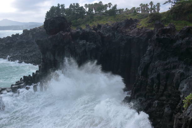 istock Cannon-dong main seungyeoli, waves, volcanic rock, dosing pillars, 1129095183