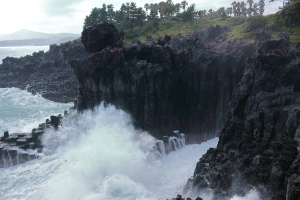 istock Cannon-dong main seungyeoli, waves, volcanic rock, dosing pillars, 1129095185