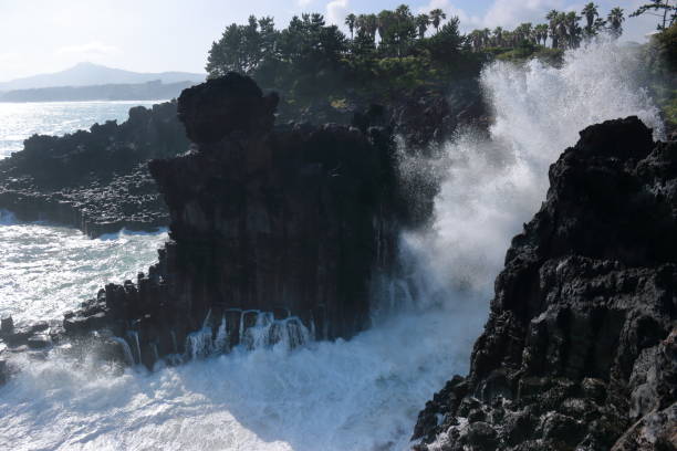 istock Cannon-dong main seungyeoli, waves, volcanic rock, dosing pillars, 1129095448
