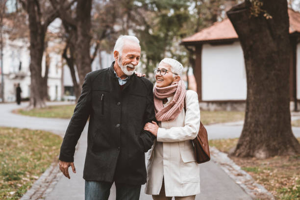 istock Happy Elderly Senior Couple In Park 1129097876