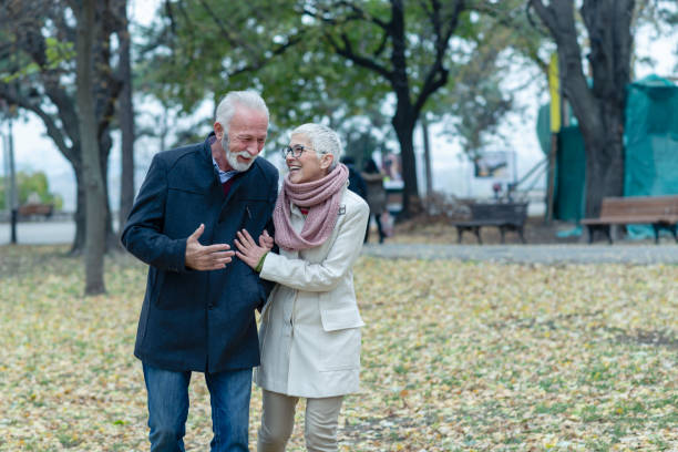 istock Happy Elder Couple Love Relaxing In Park 1129098306