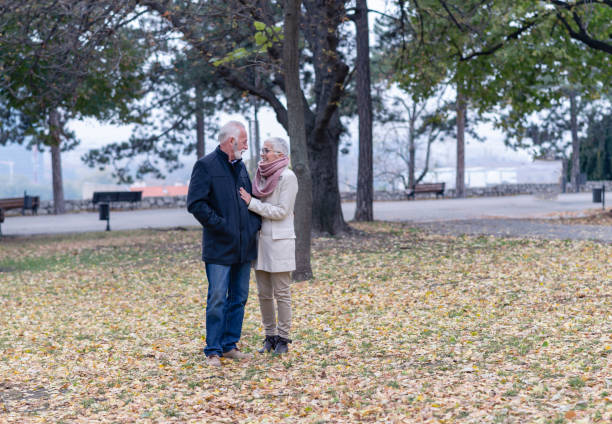 istock Happy Elderly Senior Couple In Park 1129098336