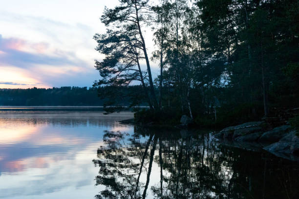 istock Sunset over a calm lake in Sweden during a summer evening 1129100876