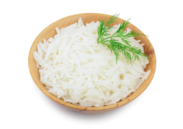 istock rice in a wooden bowl isolated on white background. Top view. Flat lay 1129101253