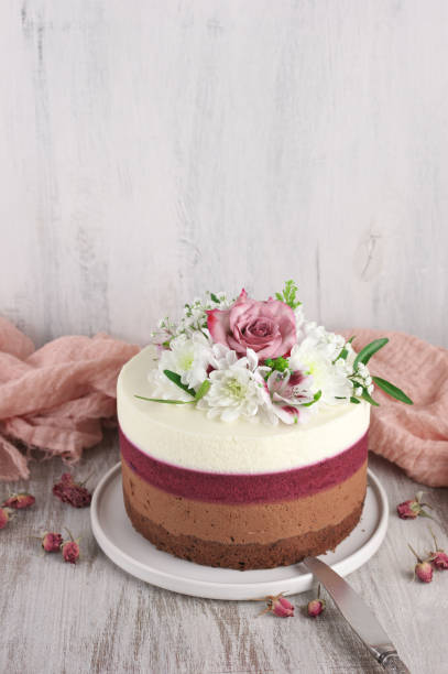 Fresh flowers decorated layered cake stock photo