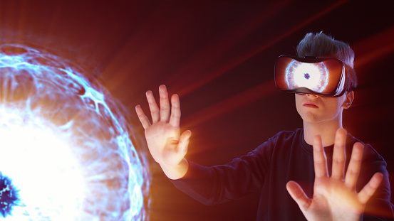 Young man wearing VR headset. Discovering magical sparks of pulsar. ASMR experience.