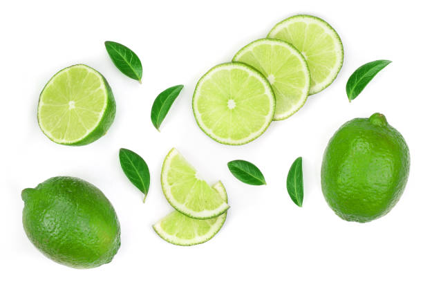 istock sliced lime with leaves isolated on white background. Top view. Flat lay pattern 1129104623