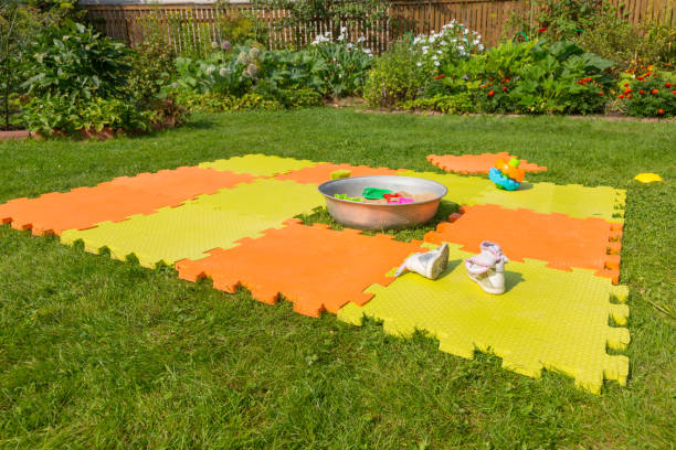 istock Color children's mat on the green grass 1129104720