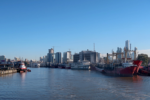 Ships at the port harbor of Buenos Aires, cityscape in the background, Argentina, South America. The Port is the leading transshipment point for the foreign trade of Argentina.