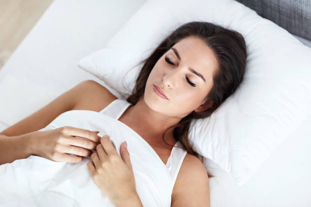 istock Young beautiful woman sleeping in bed 1129108703