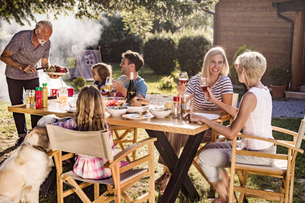 istock Happy multi-generation family enjoying in lunch time at their back yard. 1129108892