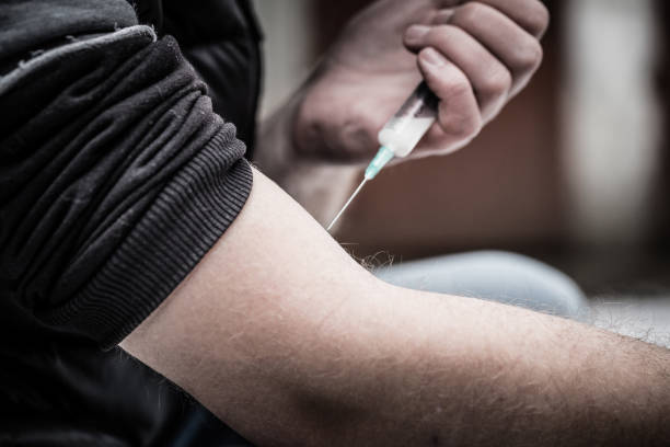 istock Heroin addict injecting his dose 1129109768