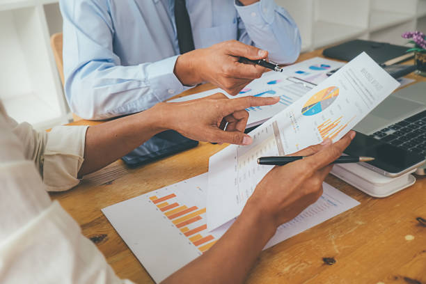 istock Business advisor analyzing financial figures denoting the progress Internal Revenue Service checking document. Audit concept 1129109811