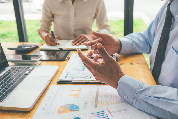 istock Business advisor analyzing financial figures denoting the progress Internal Revenue Service checking document. Audit concept 1129109813