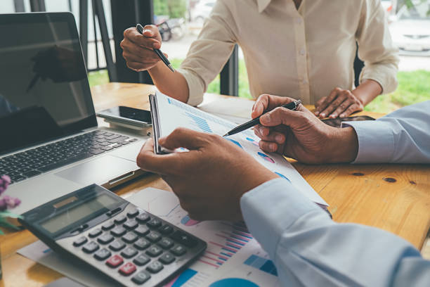 istock Business advisor analyzing financial figures denoting the progress Internal Revenue Service checking document. Audit concept 1129109815
