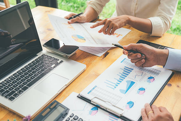 istock Business advisor analyzing financial figures denoting the progress Internal Revenue Service checking document. Audit concept 1129109819