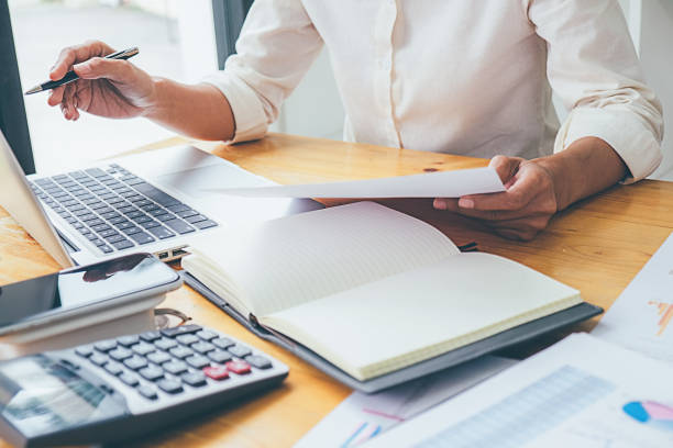 istock Business advisor analyzing financial figures denoting the progress Internal Revenue Service checking document. Audit concept 1129109843