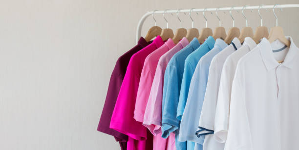 istock Men shirts hanging in row on rack 1129110293