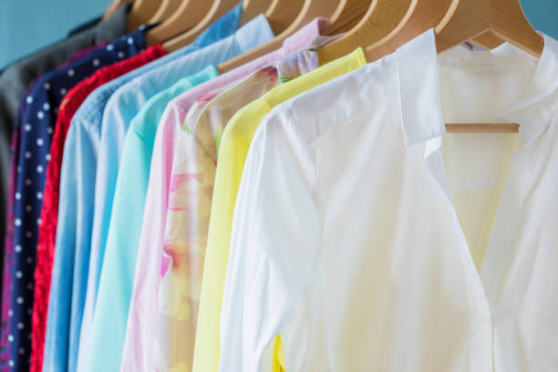istock Female clothes hanging on rack 1129110505