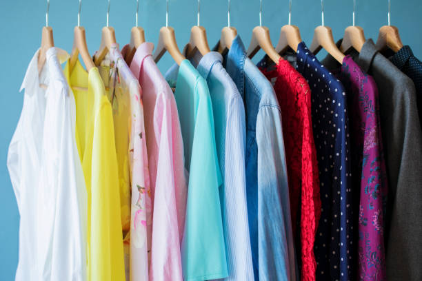 istock Women clothes hanging in row in closet 1129110507