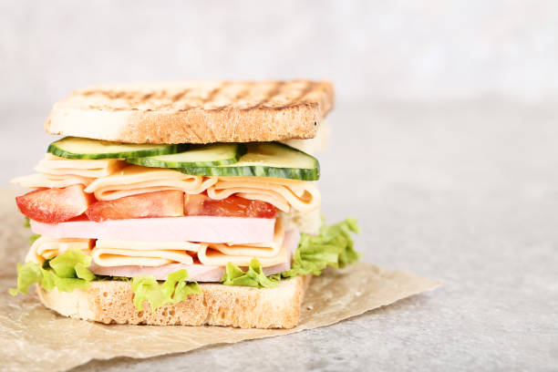 istock Sandwich with ham and vegetables on gray background 1129112019