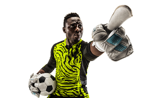 One african male soccer player goalkeeper pointing away and screaming isolated on white background. Appeal to the judge and human emotions concept