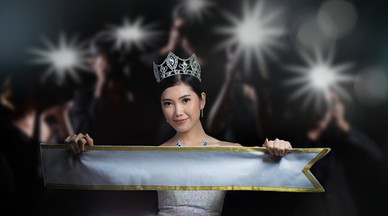 Miss Pageant beauty contest with Silver Diamond Crown white sparkle sequin hold Blank empty Sash type text word, with back view of reporter photographers shoot photo fire flash light to queen of night