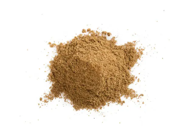 Pile of cumin powder isolated on white background. Heap of ground caraway.