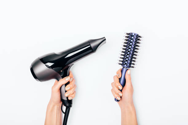 istock Top view woman's hands holding hair dryer 1129113424