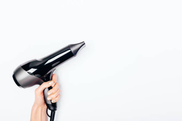 istock Top view woman's hand holding black hair dryer 1129113431