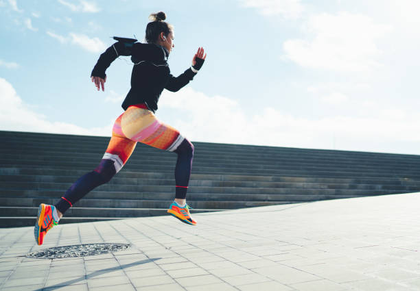 Sportswoman sprinting in the city Young woman running in Barcelona womens track stock pictures, royalty-free photos & images