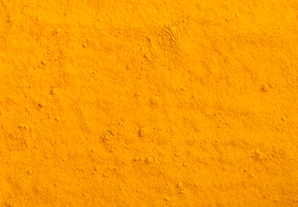 textura de polvo de cúrcuma. fondo de la especia de cúrcuma amarillo. - cúrcuma fotos fotografías e imágenes de stock