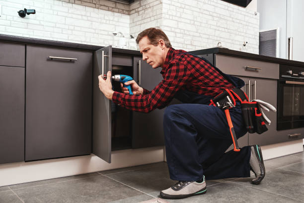 istock Master-hand work. Full size of seniour handyman repairing kitchen cabinet 1129117153