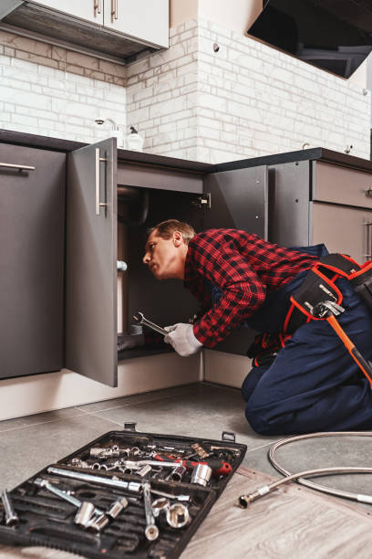 istock Tools case. Seniour handyman repairing washbasin at the kitchen 1129117201